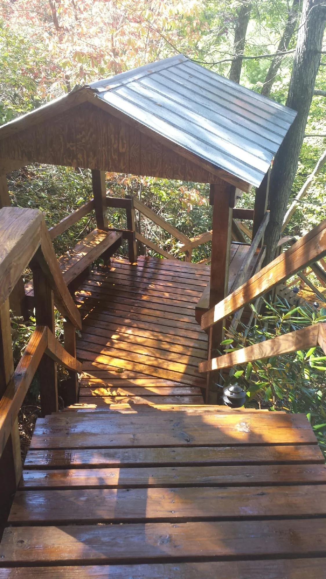 Freshly stained wood walkway and covered shelter with a metal roof in Pine Island